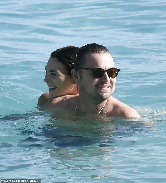 ‘Tamed’ Leonardo DiCaprio, 50, beams as girlfriend Vittoria Ceretti, 26, shows off sizzling figure in thong bikini